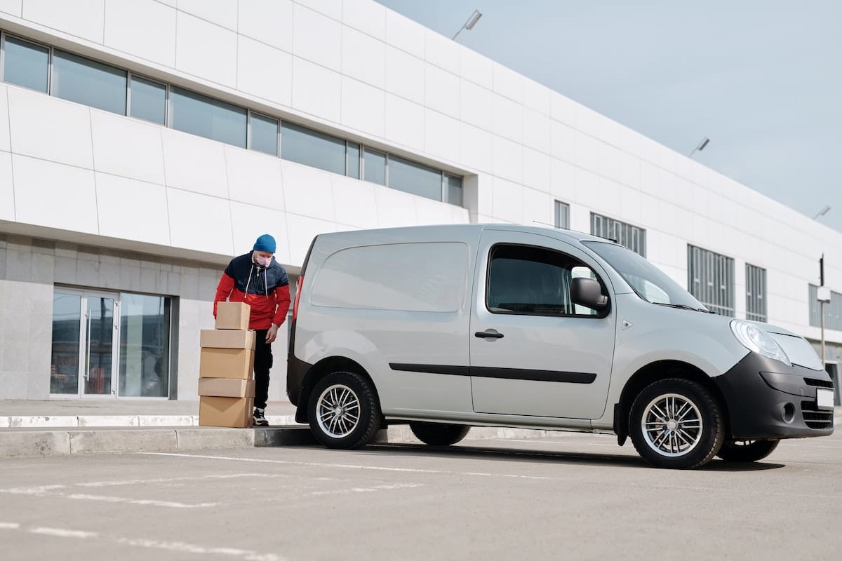 Guy loading a silver Van