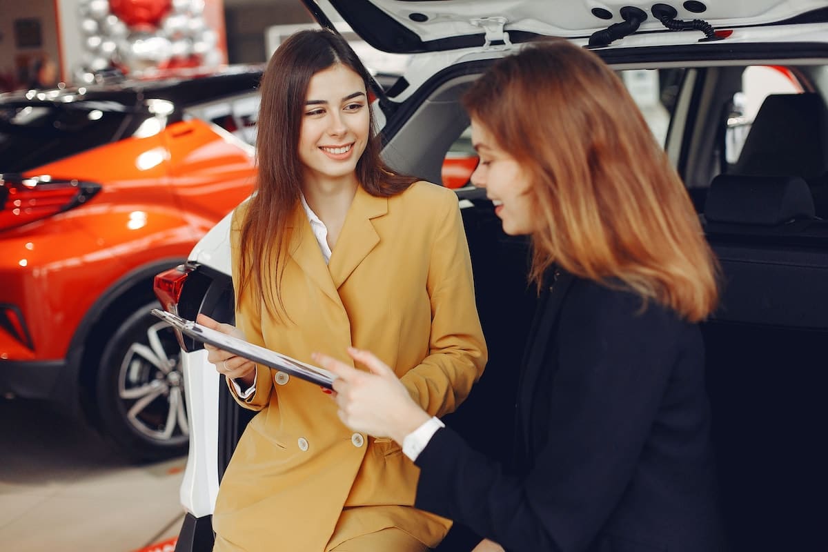Ladies in a car dealership