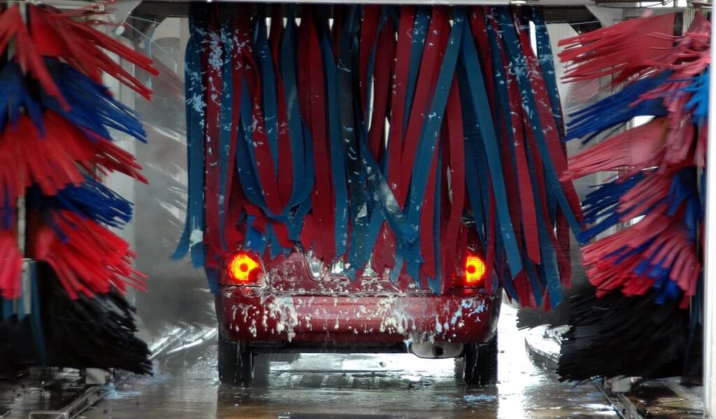Red car in an automatic car wash