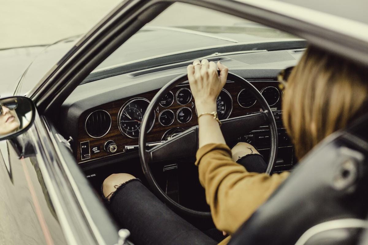 Lady driving a classic american car
