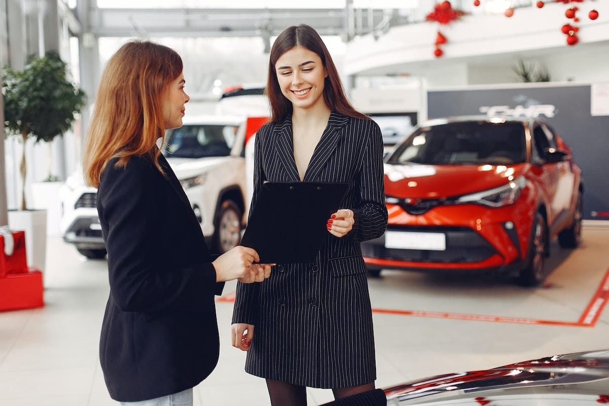 Car Dealership with two ladies speaking
