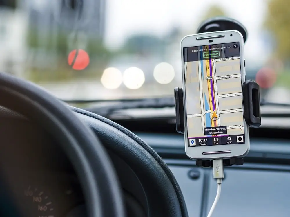 Smartphone mounted on dashboard showing Sat Nav app