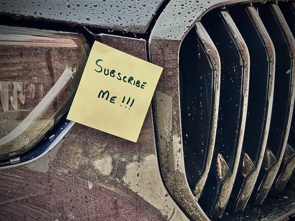 BMW Car with a yellow post it attached saying "Subscribe Me"