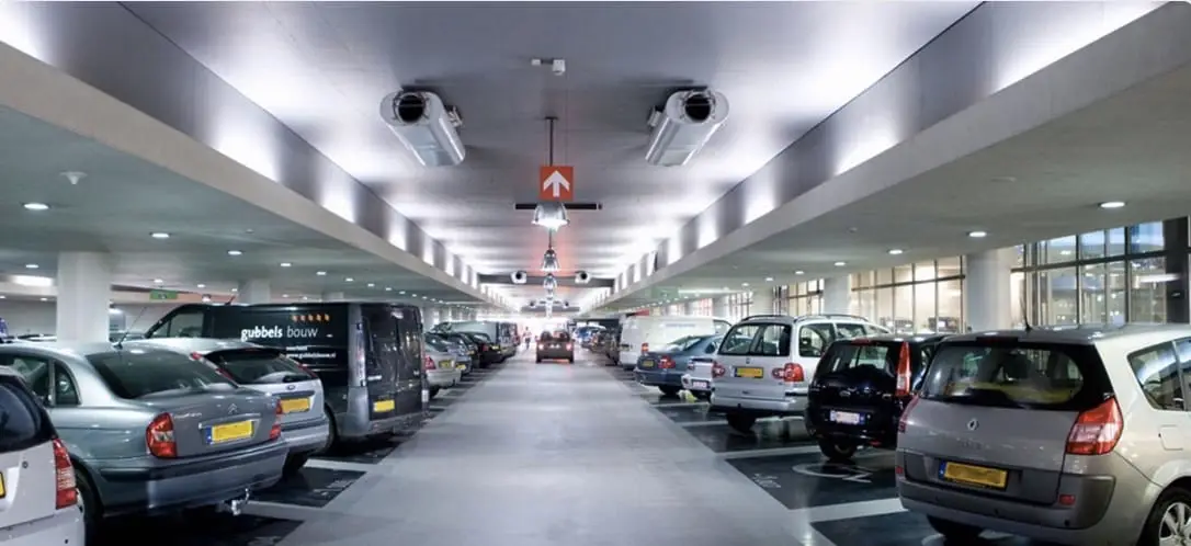 Inside one of Q-Parks facilities with cars parked within the bays